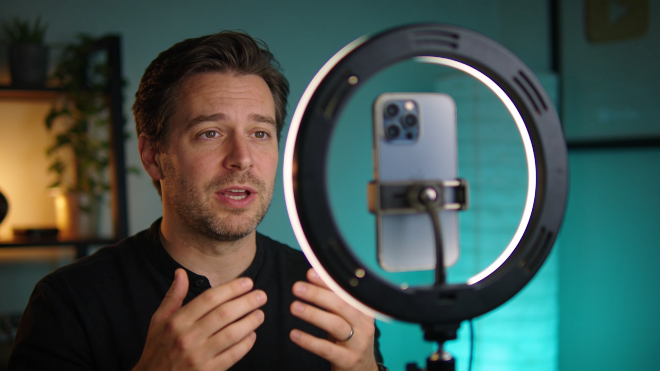 Creator filming a vertical video with a phone on a tripod and a ring light