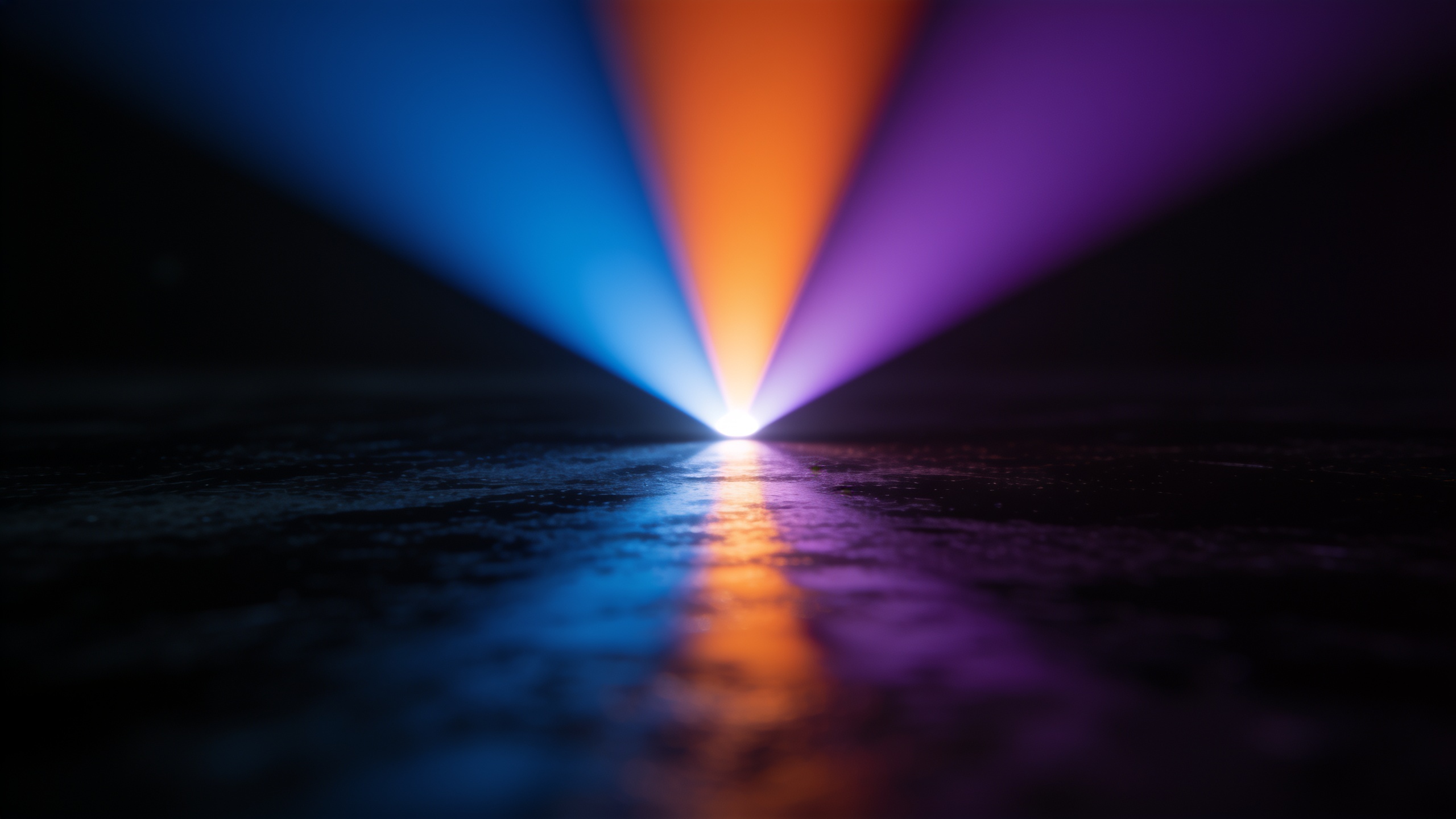 Three colored streams of light merging into one beam