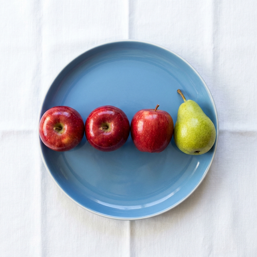 Nano Banana Pro: Three red apples and one green pear arranged in a single row on a blue plate, top-down view, white tablecloth
