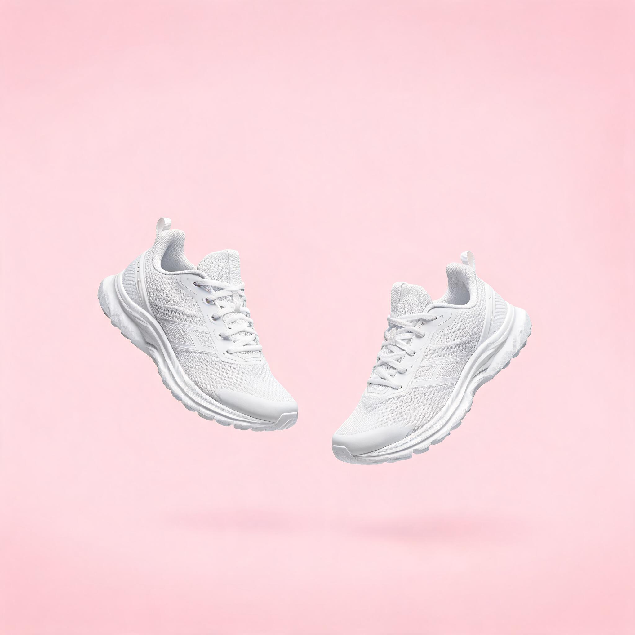 Seedream 5.0: A pair of white running shoes floating mid-air over a pastel pink background, even studio lighting, catalogue shot