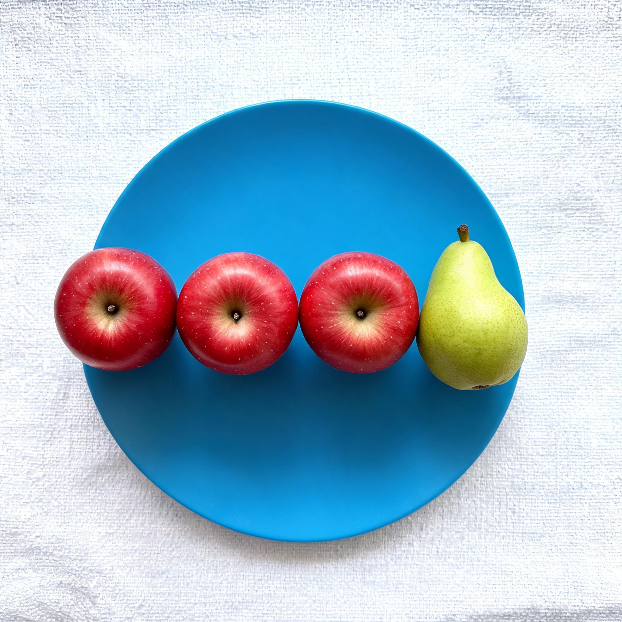Seedream 5.0: Three red apples and one green pear arranged in a single row on a blue plate, top-down view, white tablecloth