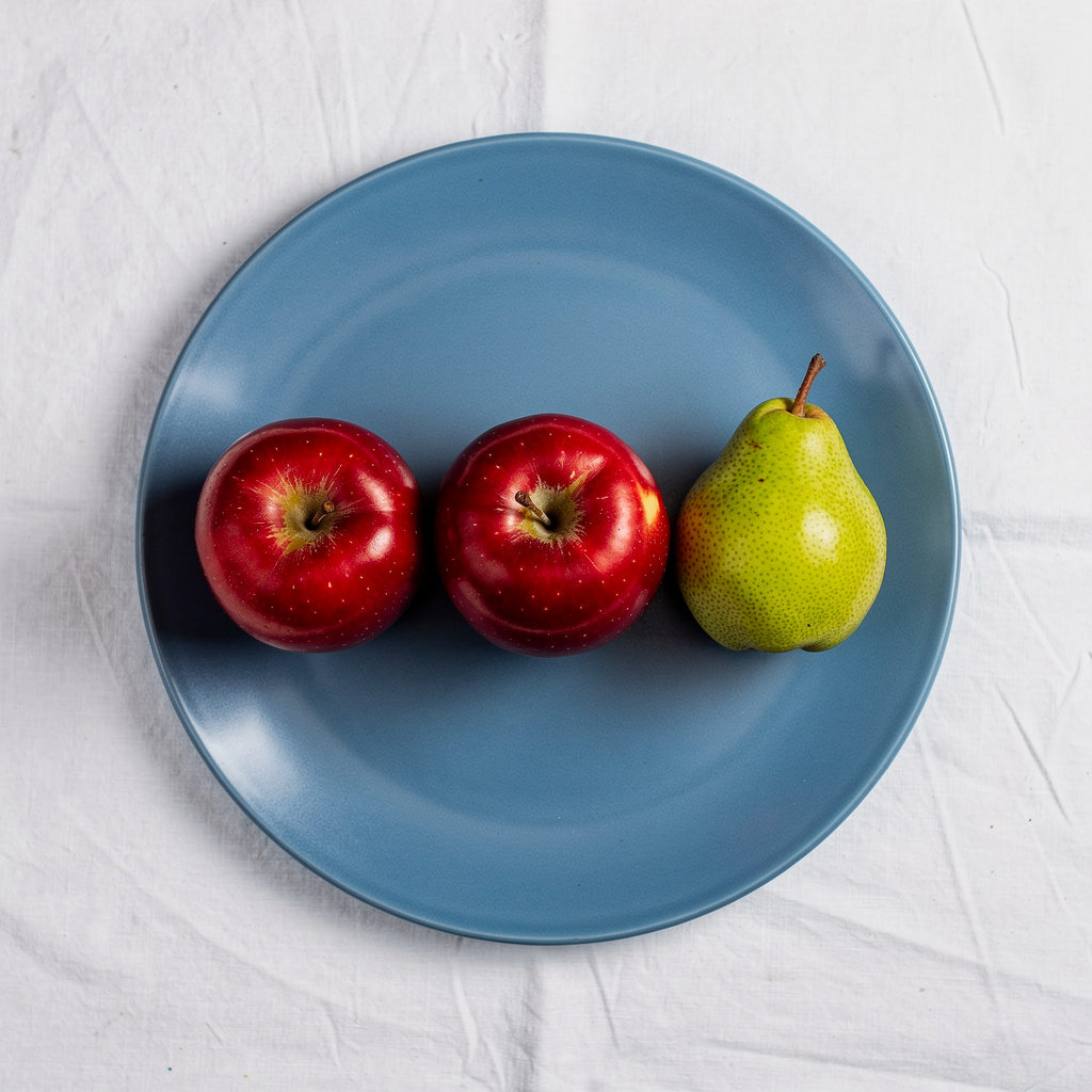 FLUX.2 Max: Three red apples and one green pear arranged in a single row on a blue plate, top-down view, white tablecloth