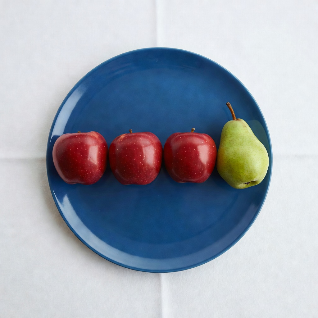 Grok Imagine: Three red apples and one green pear arranged in a single row on a blue plate, top-down view, white tablecloth
